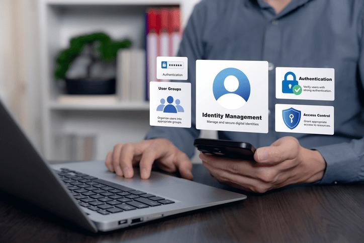 Manos sobre un port&aacute;til con iconos de gesti&oacute;n de identidades y control de acceso superpuestos